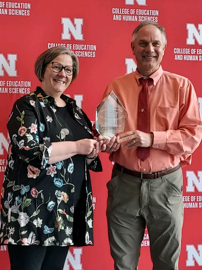 Dean Sherri Jones makes the award presentation to Professor Kiewra