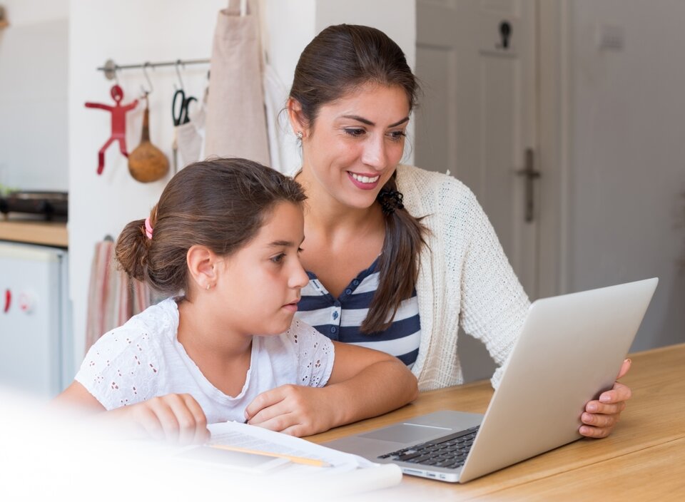 woman with child looking at laptop.